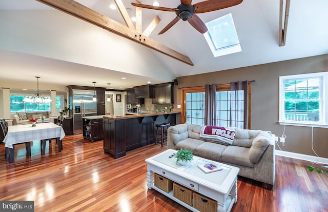 496 Black Swan Ln, Berwyn, PA 19312 - living room featuring a ceiling fan, beamed ceiling, wood finished floors, recessed lighting, and a skylight