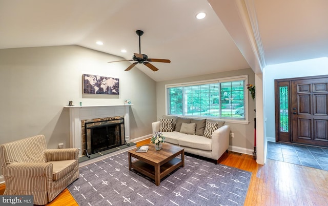 496 Black Swan Ln, Berwyn, PA 19312 - living room with a ceiling fan, vaulted ceiling, a fireplace with raised hearth, wood finished floors, and recessed lighting