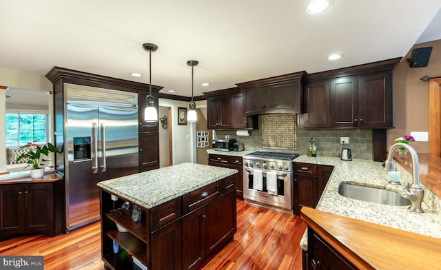 496 Black Swan Ln, Berwyn, PA 19312 - kitchen with high quality appliances, light wood-style flooring, dark brown cabinets, and recessed lighting