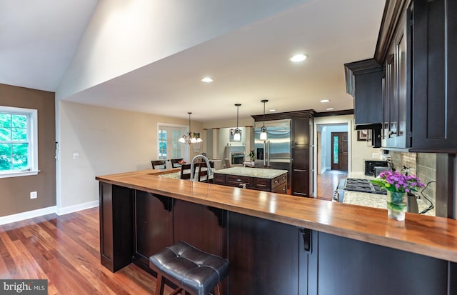 496 Black Swan Ln, Berwyn, PA 19312 - kitchen featuring butcher block counters, a kitchen island, dark wood finished floors, a chandelier, and decorative light fixtures