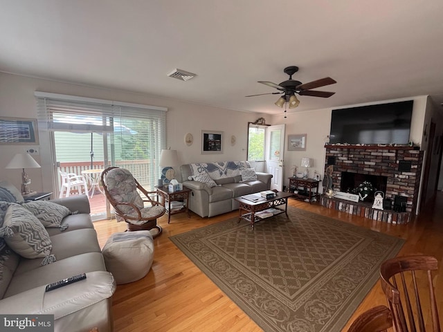18 N 19th St, Surf City, NJ 08008 - living area featuring wood finished floors, a ceiling fan, and a brick fireplace