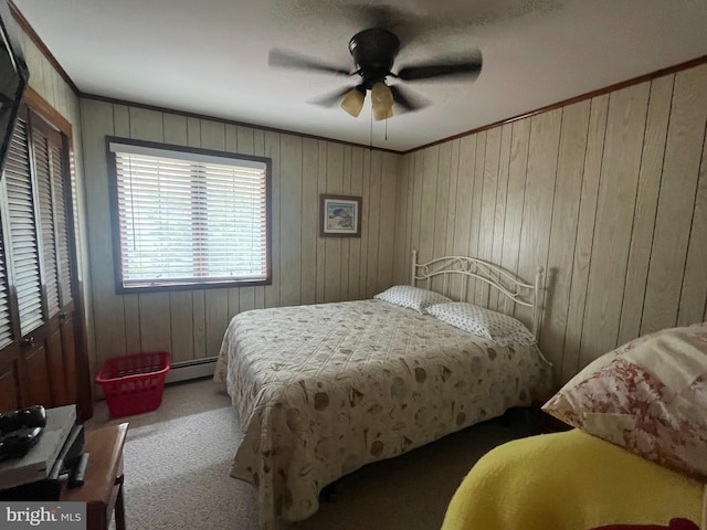 18 N 19th St, Surf City, NJ 08008 - carpeted bedroom featuring a baseboard heating unit, crown molding, wood walls, and ceiling fan