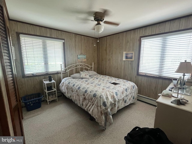 18 N 19th St, Surf City, NJ 08008 - carpeted bedroom with baseboard heating, wooden walls, and a ceiling fan