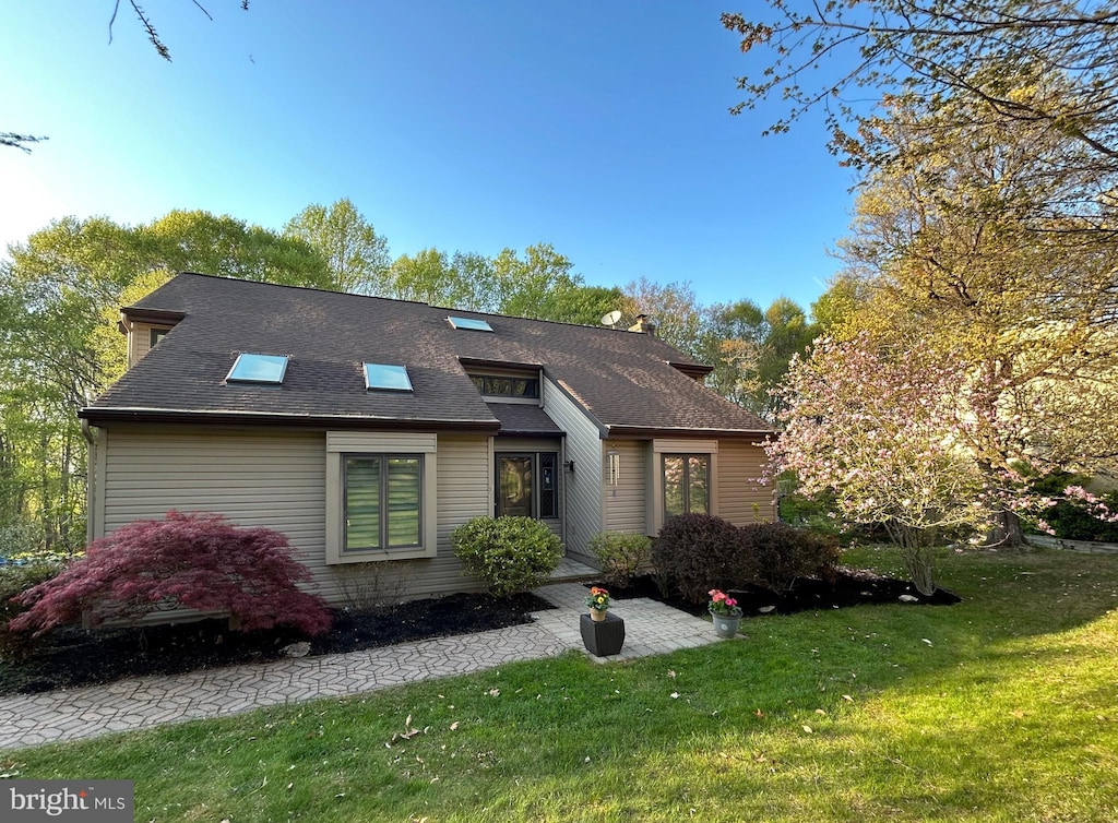 112 Birch Dr, Downingtown, PA 19335 - view of front of house featuring a front lawn, a shingled roof, and a chimney