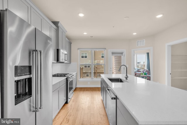 9660 Fields Rd Unit 9660, Gaithersburg, MD 20878 - kitchen with high quality appliances, light wood-style flooring, recessed lighting, an island with sink, and gray cabinets