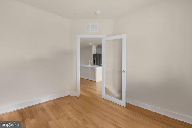 9660 Fields Rd Unit 9660, Gaithersburg, MD 20878 - empty room with light wood finished floors and a smoke detector