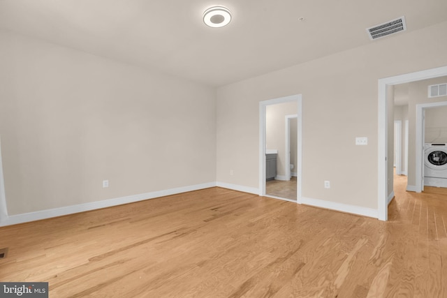 9660 Fields Rd Unit 9660, Gaithersburg, MD 20878 - unfurnished bedroom with washer / clothes dryer, light wood-style flooring, and connected bathroom