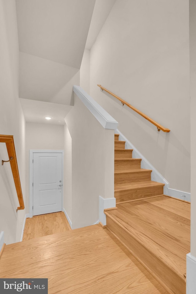 9660 Fields Rd Unit 9660, Gaithersburg, MD 20878 - staircase featuring wood finished floors and a towering ceiling