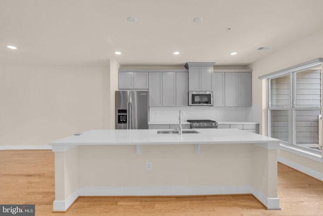9660 Fields Rd Unit 9660, Gaithersburg, MD 20878 - kitchen with stainless steel appliances, gray cabinets, a kitchen island with sink, light countertops, and recessed lighting