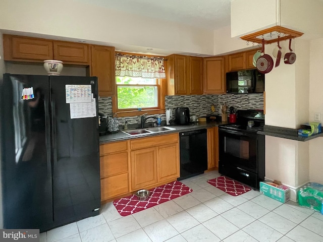 433 Williams St, Cumberland, MD 21502 - kitchen with black appliances, dark countertops, backsplash, light tile patterned floors, and brown cabinetry