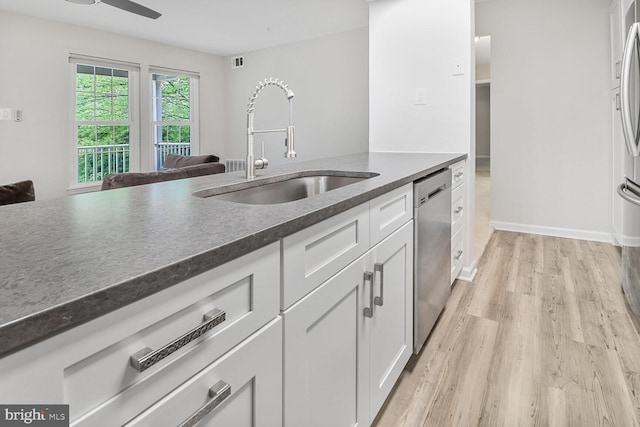 3121 Katewood Ct, Baltimore, MD 21209 - kitchen with dishwasher, dark countertops, light wood-style flooring, white cabinetry, and a ceiling fan