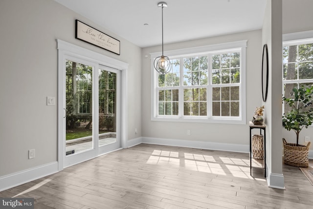 4245 Mechanicsville Rd, Doylestown, PA 18902 - unfurnished dining area with light wood-type flooring and a chandelier