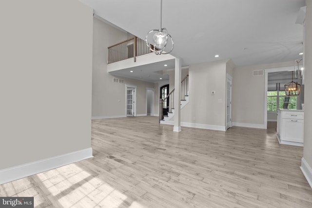 4245 Mechanicsville Rd, Doylestown, PA 18902 - unfurnished living room featuring a chandelier, stairs, light wood-style flooring, and recessed lighting
