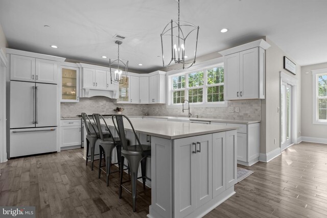 4245 Mechanicsville Rd, Doylestown, PA 18902 - kitchen with high end refrigerator, white cabinetry, light countertops, a center island, and glass insert cabinets