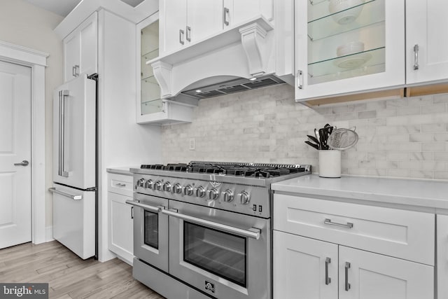 4245 Mechanicsville Rd, Doylestown, PA 18902 - kitchen featuring high end appliances, custom exhaust hood, light countertops, and white cabinetry