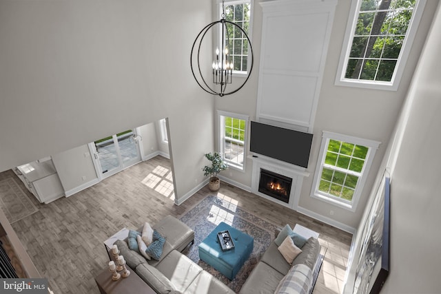 4245 Mechanicsville Rd, Doylestown, PA 18902 - living room with a chandelier, plenty of natural light, a high ceiling, and wood finished floors
