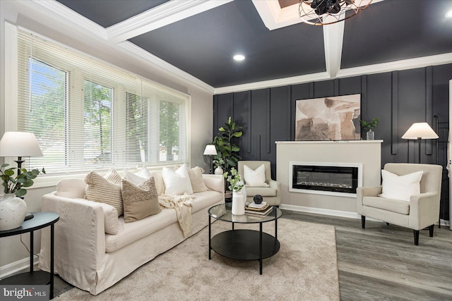 105 Concove Way, Havre De Grace, MD 21078 - living area featuring crown molding, wood finished floors, a glass covered fireplace, a decorative wall, and a chandelier
