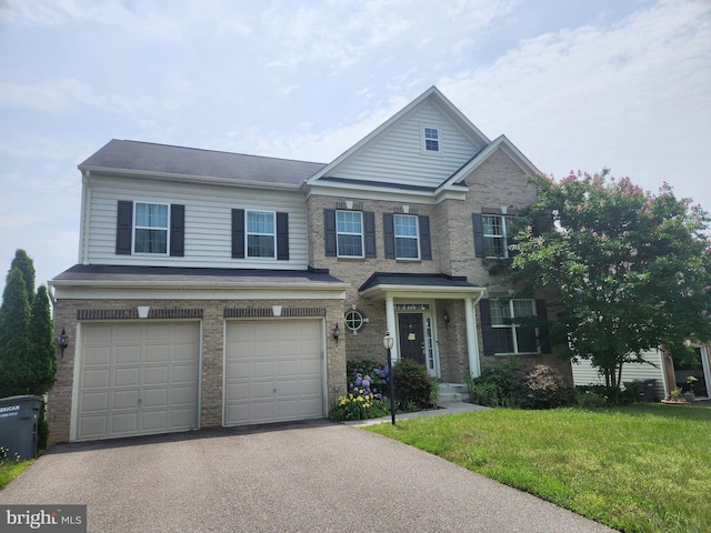 15844 Eagle Feather Dr, Woodbridge, VA 22191 - traditional-style home featuring asphalt driveway, a garage, brick siding, and a front yard