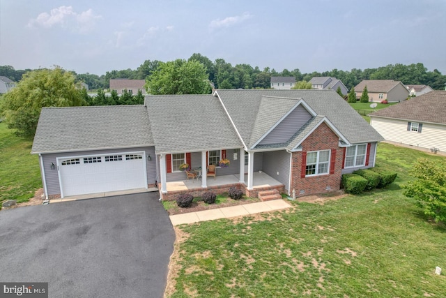 132 Nightingale Dr, Milford, DE 19963 - view of front of property featuring an attached garage, covered porch, asphalt driveway, a front yard, and a shingled roof