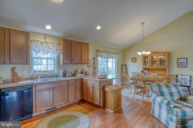 132 Nightingale Dr, Milford, DE 19963 - kitchen featuring dishwasher, a peninsula, plenty of natural light, lofted ceiling, and light countertops