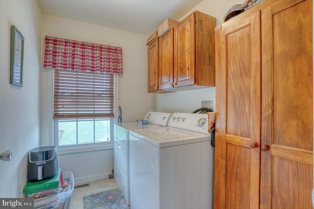 132 Nightingale Dr, Milford, DE 19963 - washroom with washing machine and clothes dryer, cabinet space, and light tile patterned floors