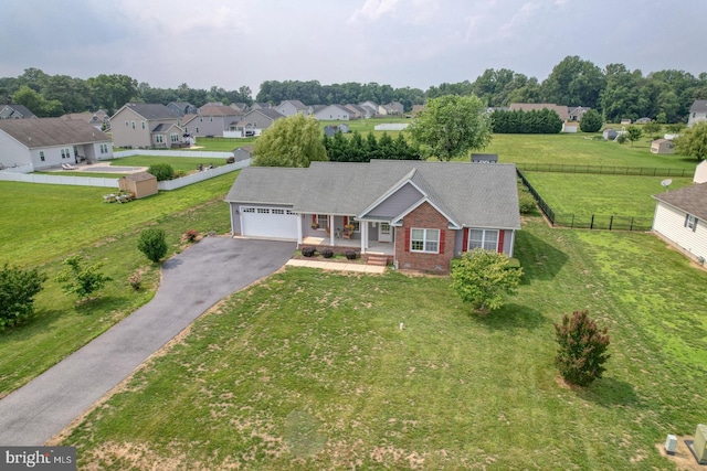 132 Nightingale Dr, Milford, DE 19963 - view of front of home featuring a garage, driveway, covered porch, brick siding, and a residential view