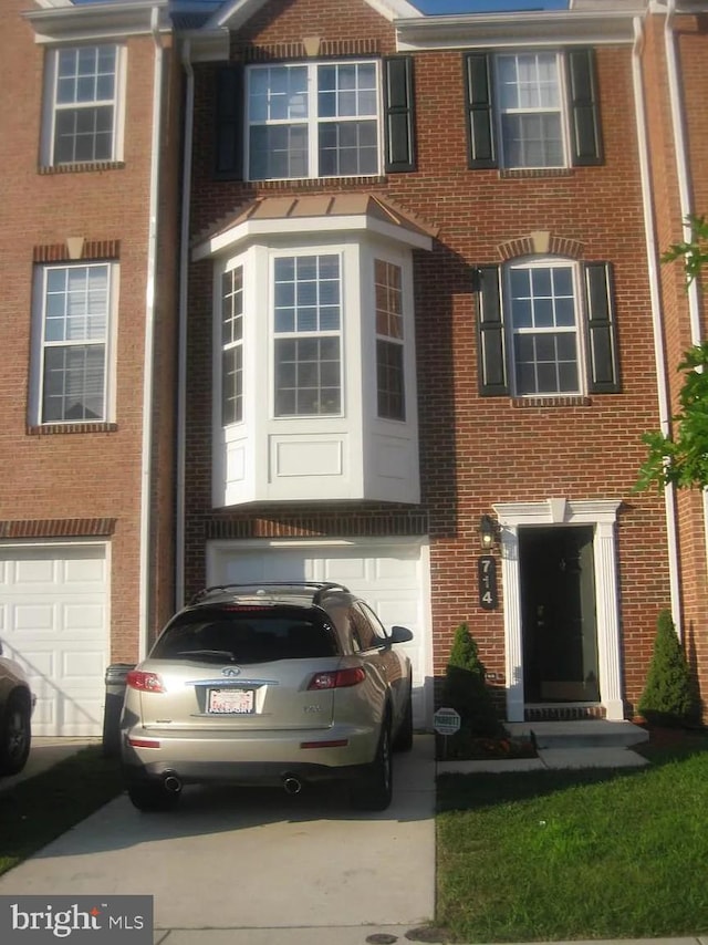 714 Parev Way, Upper Marlboro, MD 20774 - townhome / multi-family property with an attached garage, brick siding, and driveway