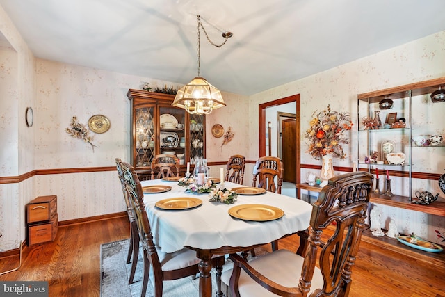 12810 Kending Ln, Clear Spring, MD 21722 - dining space with wallpapered walls, a chandelier, and wood finished floors