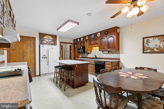 12810 Kending Ln, Clear Spring, MD 21722 - kitchen featuring black appliances, light countertops, ventilation hood, and a breakfast bar