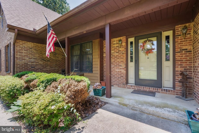 12810 Kending Ln, Clear Spring, MD 21722 - view of exterior entry with brick siding, covered porch, and a shingled roof