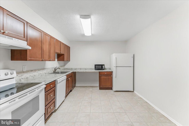 400 Glendale Rd Unit G-13, Havertown, PA 19083 - kitchen with white appliances, under cabinet range hood, a textured ceiling, light countertops, and brown cabinets