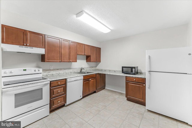 400 Glendale Rd Unit G-13, Havertown, PA 19083 - kitchen with white appliances, under cabinet range hood, light countertops, a textured ceiling, and brown cabinets