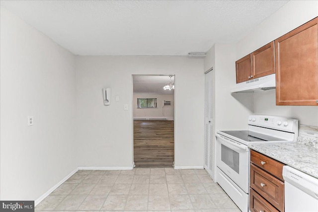 400 Glendale Rd Unit G-13, Havertown, PA 19083 - kitchen featuring white appliances, under cabinet range hood, light countertops, brown cabinets, and a chandelier