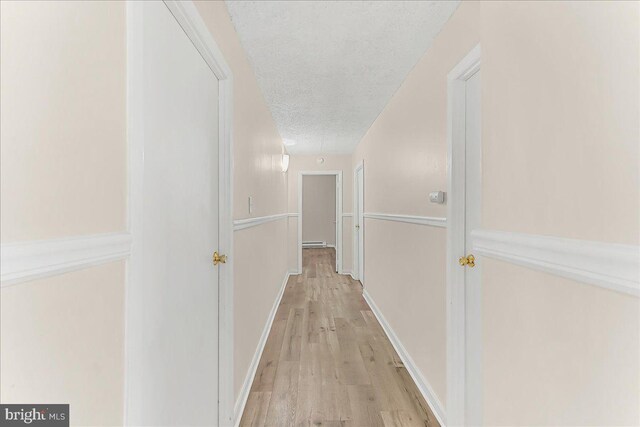 400 Glendale Rd Unit G-13, Havertown, PA 19083 - corridor with a textured ceiling, a baseboard heating unit, and light wood-type flooring