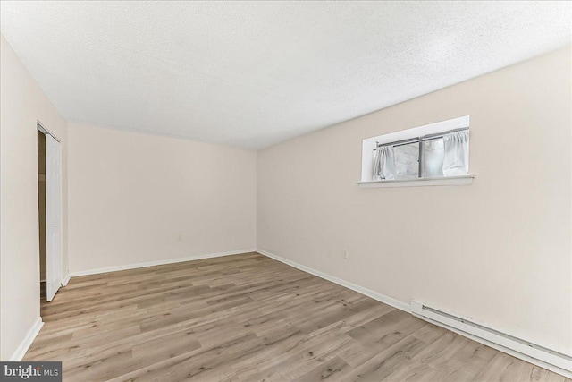 400 Glendale Rd Unit G-13, Havertown, PA 19083 - spare room featuring a baseboard heating unit, wood finished floors, and a textured ceiling