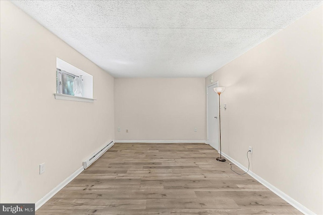 400 Glendale Rd Unit G-13, Havertown, PA 19083 - spare room featuring a baseboard heating unit, wood finished floors, and a textured ceiling