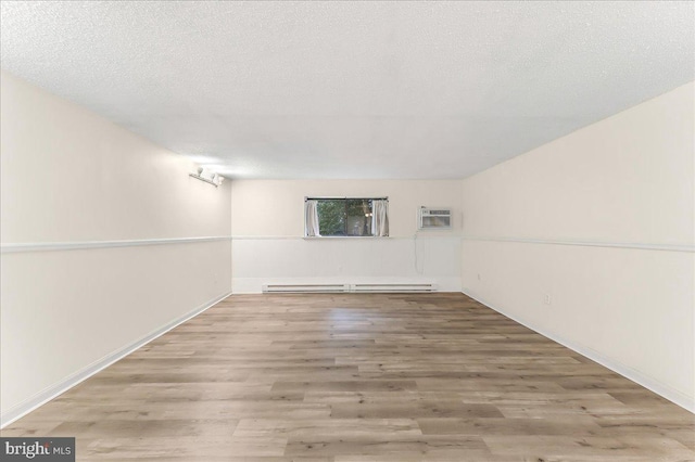 400 Glendale Rd Unit G-13, Havertown, PA 19083 - spare room featuring a baseboard radiator, wood finished floors, and a wall mounted AC