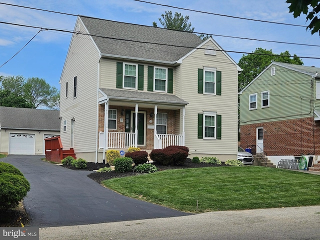 1119 Secane Rd, Secane, PA 19018 - traditional home featuring covered porch, an outbuilding, a front lawn, a shingled roof, and asphalt driveway