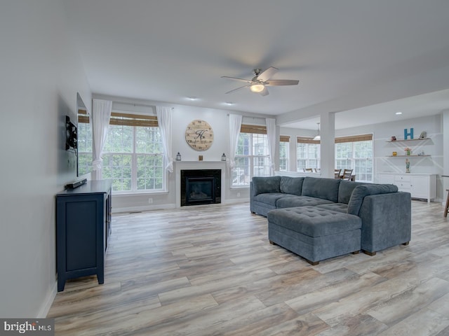 7436 Pensacola Pl, Gainesville, VA 20155 - living area featuring ceiling fan, healthy amount of natural light, light wood-type flooring, and a glass covered fireplace