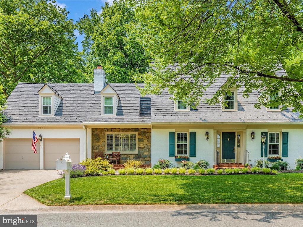 213 Midsummer Cir, Gaithersburg, MD 20878 - new england style home with concrete driveway, a chimney, a front lawn, and stone siding