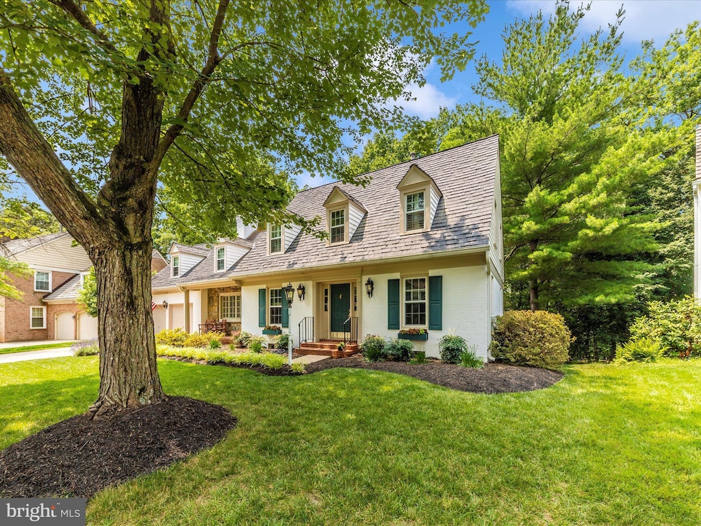 213 Midsummer Cir, Gaithersburg, MD 20878 - cape cod house with a front lawn, brick siding, and a garage