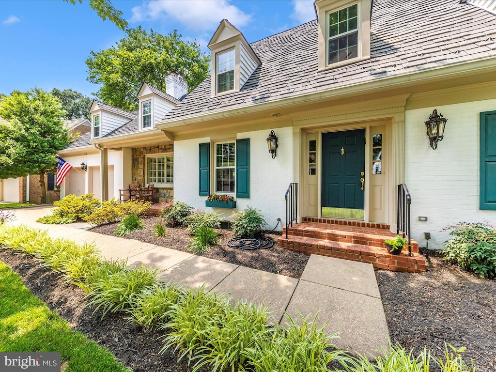 213 Midsummer Cir, Gaithersburg, MD 20878 - doorway to property featuring a high end roof, an attached garage, a chimney, and covered porch