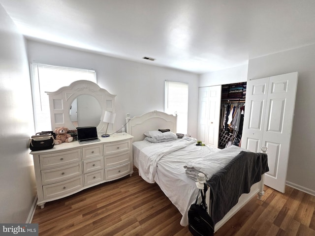 6529 Huntshire Dr, Elkridge, MD 21075 - bedroom with dark wood-style floors, multiple windows, and a closet