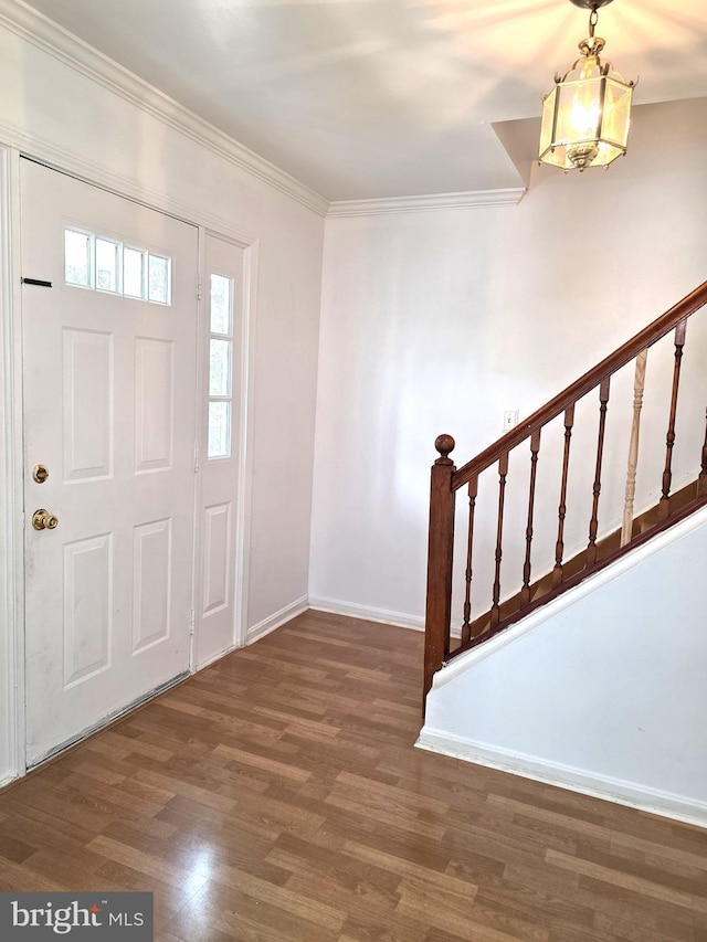 6529 Huntshire Dr, Elkridge, MD 21075 - entryway featuring a chandelier, wood finished floors, ornamental molding, and stairway