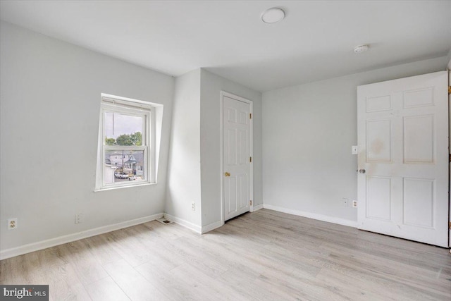 301 Broad St, Beverly, NJ 08010 - unfurnished bedroom with light wood-style flooring and baseboards