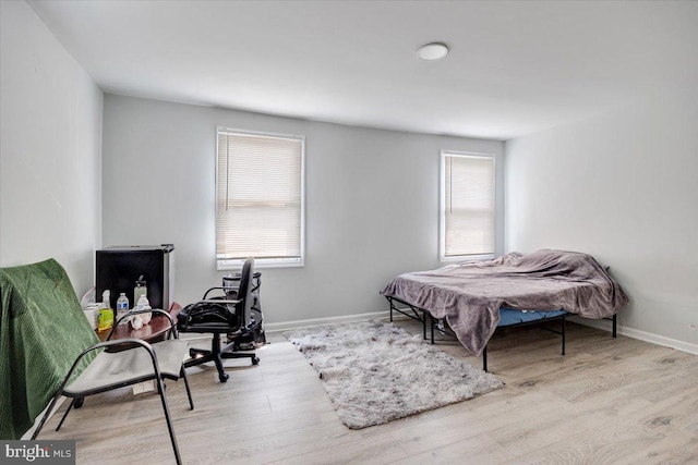 301 Broad St, Beverly, NJ 08010 - bedroom with multiple windows and wood finished floors