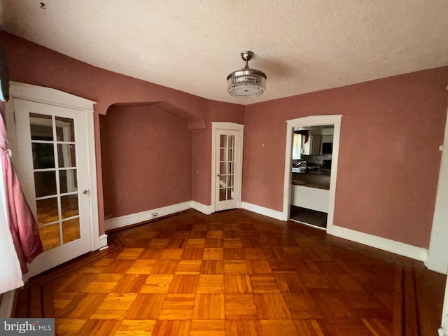 5122 Stenton Ave, Philadelphia, PA 19144 - empty room with a textured ceiling and arched walkways