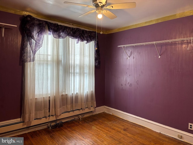 5122 Stenton Ave, Philadelphia, PA 19144 - spare room featuring baseboard heating, wood finished floors, a ceiling fan, and ornamental molding