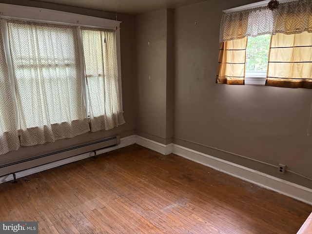 5122 Stenton Ave, Philadelphia, PA 19144 - unfurnished living room featuring hardwood / wood-style floors and a baseboard heating unit