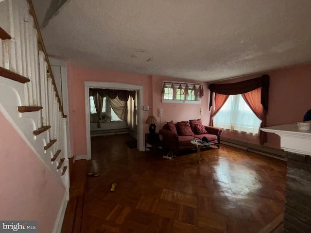 5122 Stenton Ave, Philadelphia, PA 19144 - living room featuring a textured ceiling, stairs, a baseboard radiator, and baseboard heating